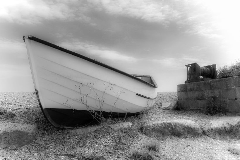 Dreamy image of a fishing boat on a Suffolk beach