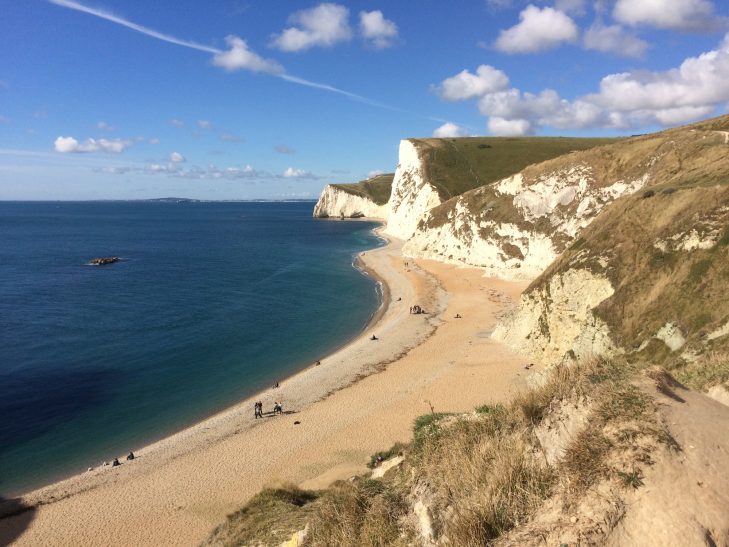 White cliffs meet a sandy beach of the Jurassic coastline in Dorset