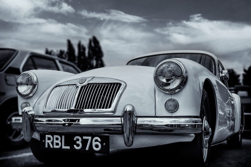 Image shows a MG MGA classic roadster in gleaming chrome and white