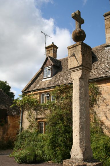 This photo shows the village cross and sundial outside Cross Cottage in Stanton, Gloucestershire