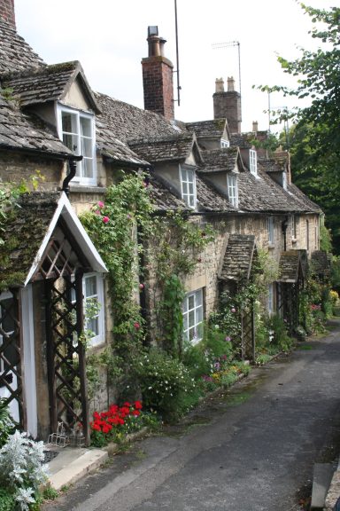This photo shows historic honey-colored stone cottages on Vineyard Street in Winchcombe, Gloucestershire.