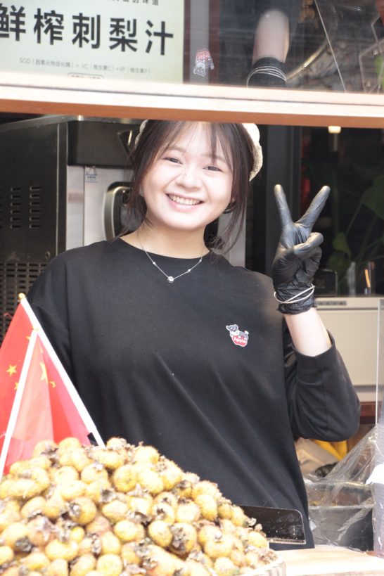 Happy Chinese foodstall workeronly too please to pose for the tourist camera