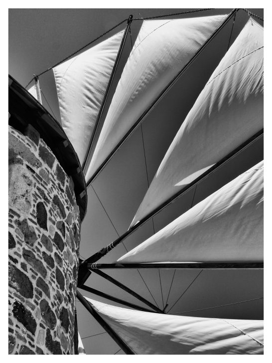 bellowing sails of an ancient windmill in Greec